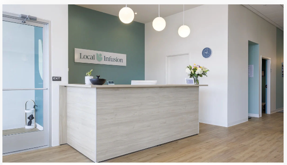 Local Infusion reception desk with a Local Infusion sign